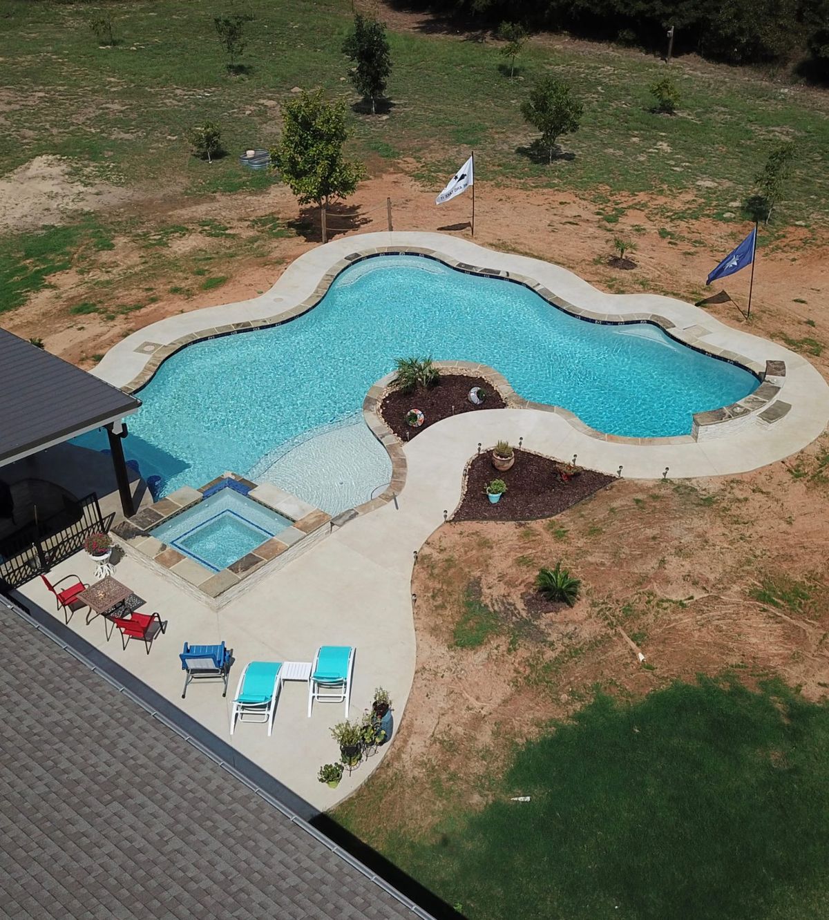 Custom pool builder in Tyler, TX — aerial view of a completed backyard pool and patio by Aqualux Pools