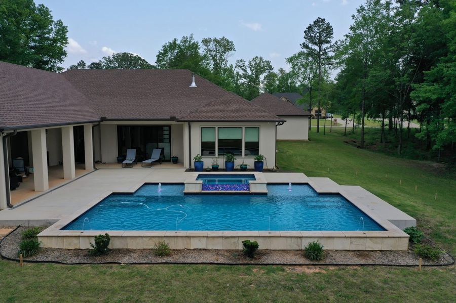Aerial view of a modern rectangular pool and attached spa in Tyler, TX