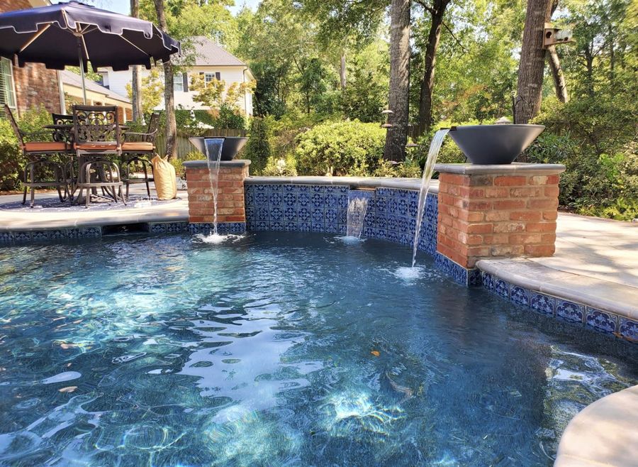 Brick and tile fountain spa wall pouring into a custom East Texas pool
